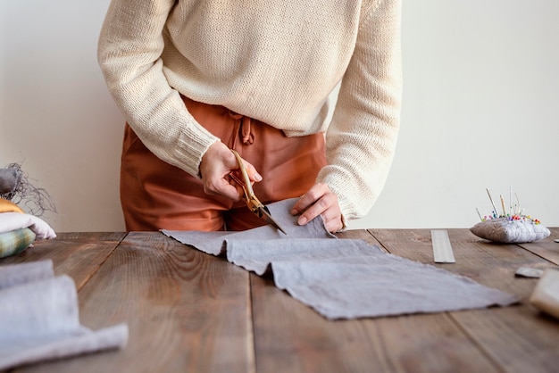 Front view tailor cutting a fabric