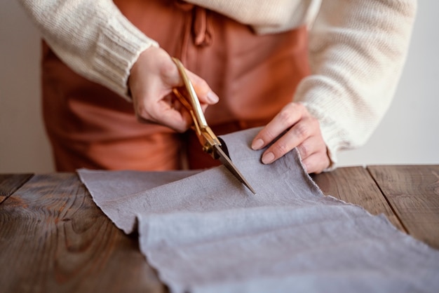 Front view tailor cutting a fabric