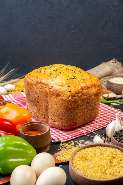 Free photo front view tasty bread colored bell peppers eggs bulgur wheat in bowl on table