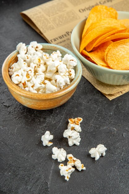 Front view tasty cheese cips with different snacks on dark background