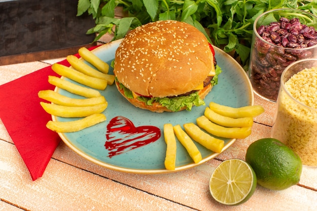 Front view tasty chicken sandwich with green salad and vegetables inside plate with french fries on the wooden cream desk.