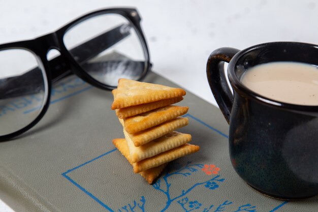 Front view tasty crisps with milk and sunglasses