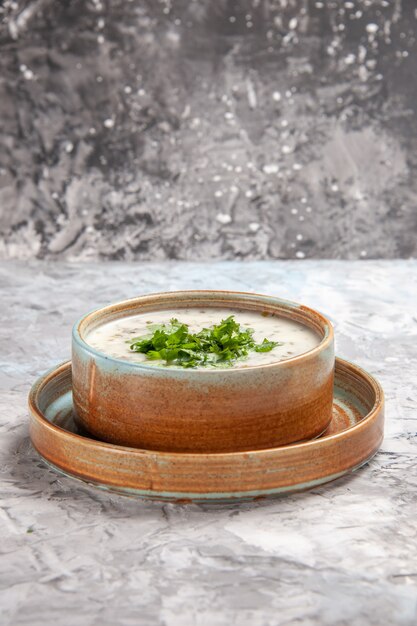 Front view tasty dovga yogurt soup with greens on white table dairy milk soup dish