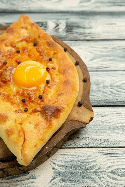 Front view tasty egg bread baked on a grey rustic desk