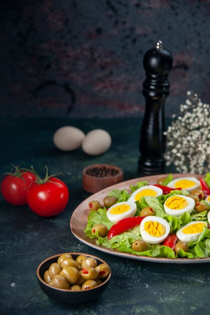 front view tasty egg salad consists of green salad and olives on dark background