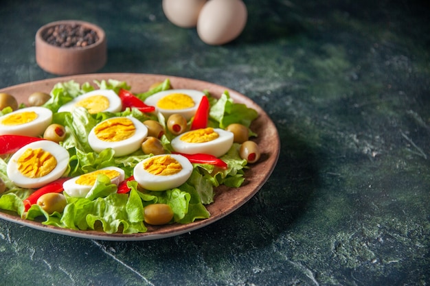 front view tasty egg salad consists of olives and green salad on dark background