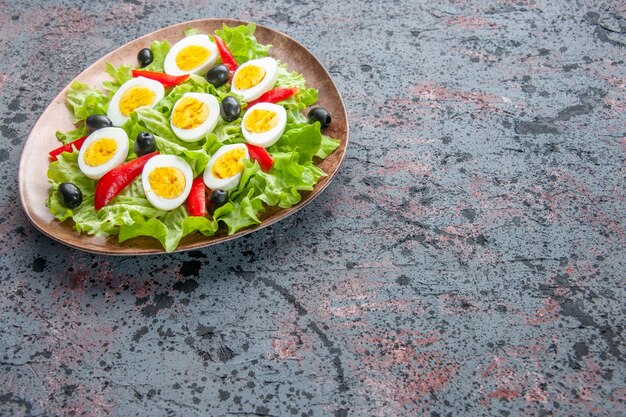 front view tasty egg salad with green salad and olives on light background