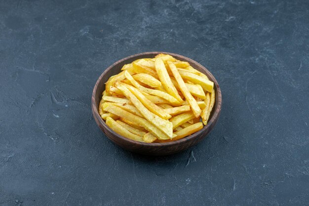 Front view tasty french fries inside plate on dark