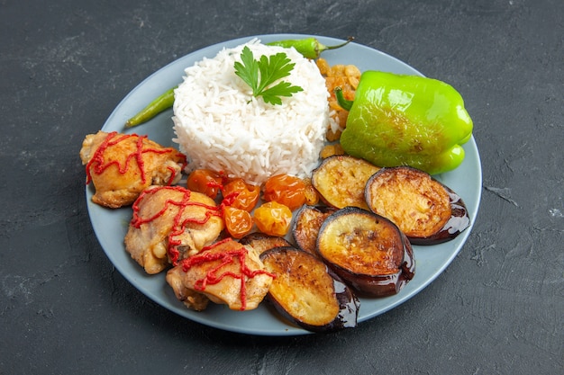 Front view tasty fried eggplants with meat cooked rice and raisins on dark surface