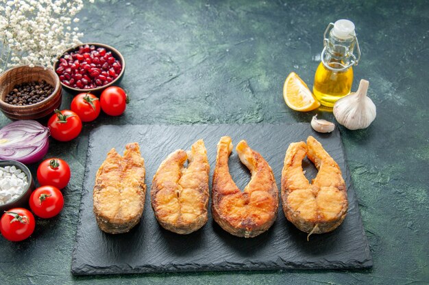 Front view tasty fried fish with tomatoes on dark surface cooking dish food salad fry meal seafood pepper sea meat