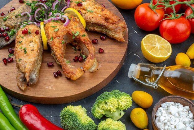 Front view tasty fried fish with vegetables and seasonings on the dark background color salad meal ocean dough food health meat seafood