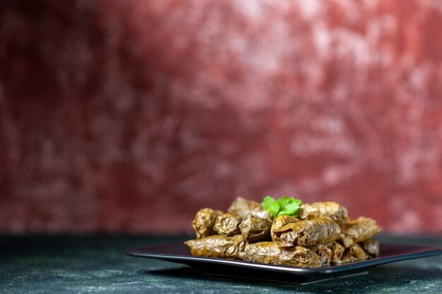 Front view tasty leaf dolma inside plate on a dark background calorie oil dinner food restaurant meal salad dish meat