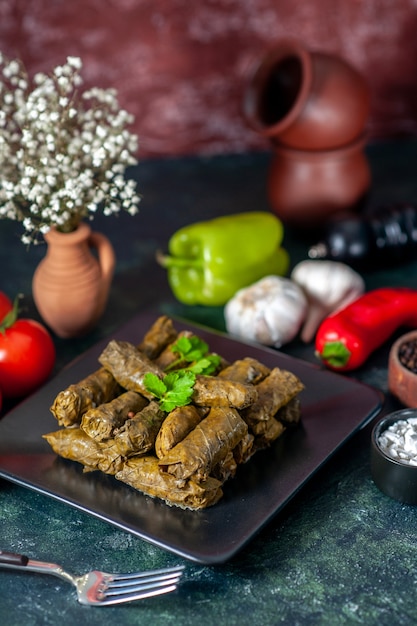 Front view tasty leaf dolma with tomatoes on dark background calorie oil dinner food salad meat restaurant meal