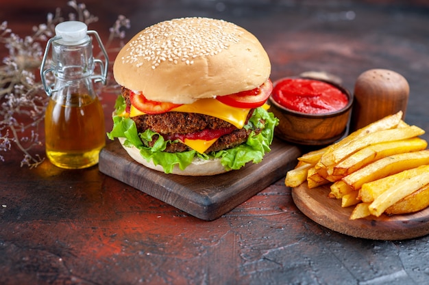 Front view tasty meat burger with french fries on dark background