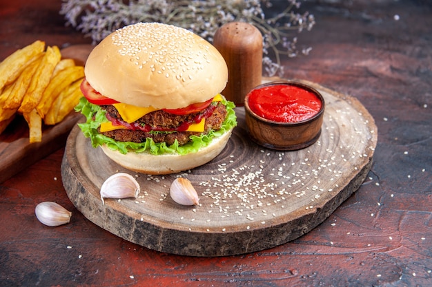 Front view tasty meat burger with french fries on dark floor