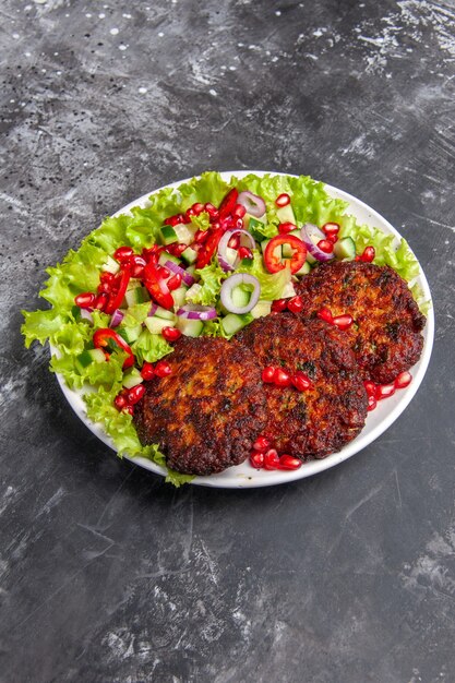 Front view tasty meat cutlets with fresh salad