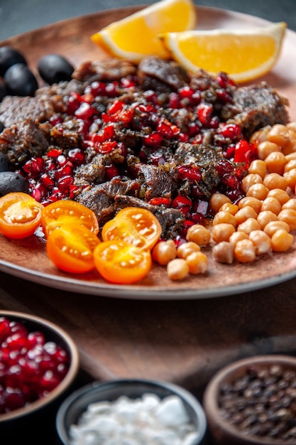 front view tasty meat slices fried meal with fruits inside plate on dark background