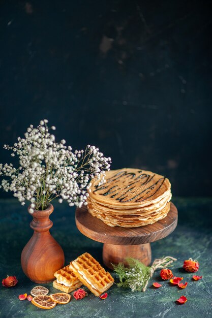 Front view tasty pancakes on dark-blue surface