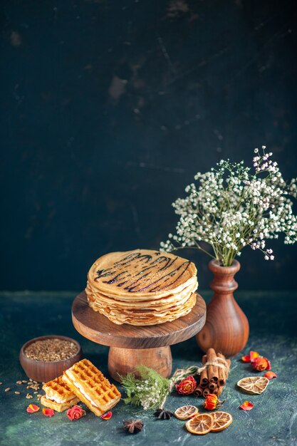 Free photo front view tasty pancakes on dark-blue surface