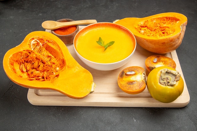 Front view tasty pumpkin soup with fresh pumpkins on the light desk dish fruit soup