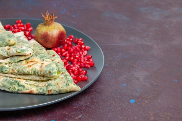 Front view tasty qutabs cooked dough pieces with greens inside on dark surface fat cooking dough dish meal