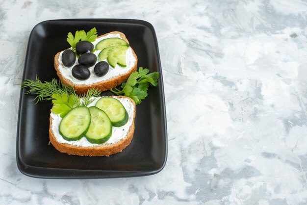 Front view tasty sandwiches with cucumbers and olives inside plate white background sandwich horizontal burger toast food lunch meal