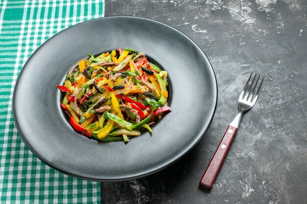 Front view tasty vegetable salad inside plate on grey table