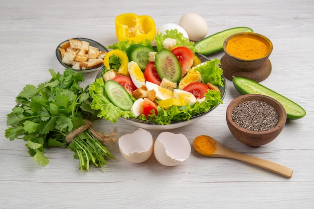 Front view tasty vegetable salad with eggs greens and seasonings on white background meal food breakfast ripe color