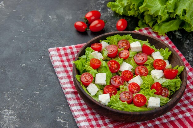 Front view tasty vegetable salad with sliced cheese tomatoes and seasonings on gray background meal food color diet lunch health