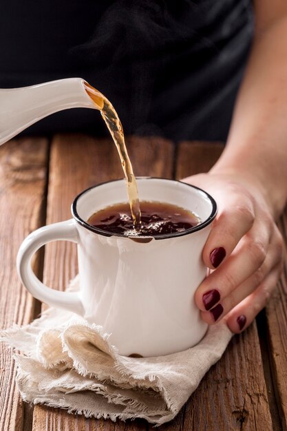 Front view of tea concept on wooden table