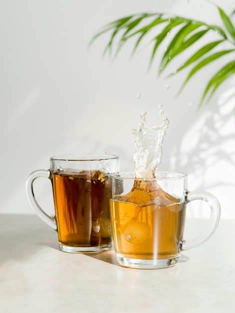 Front view tea splashing in glass