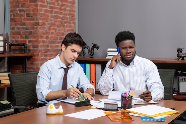 Front view team work process colleagues having business negotiations in modern office