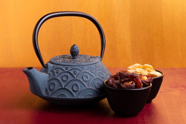 Front view of teapot and delicacies for chinese new year