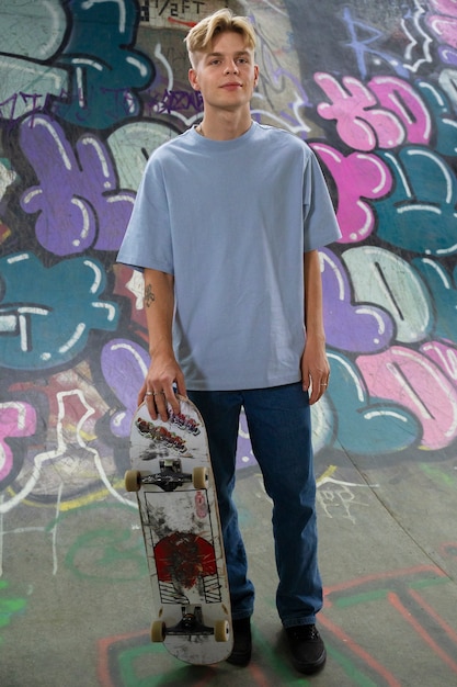 Free photo front view teen with skateboard