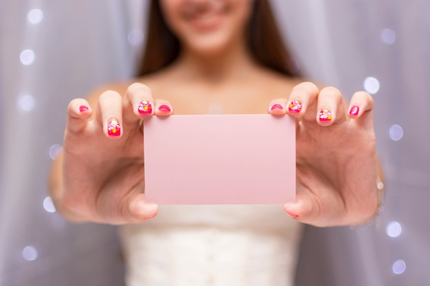 Front view teenage girl holding a pink birthday card