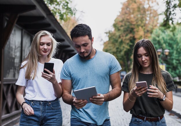 Front view teens checking their message on phones 