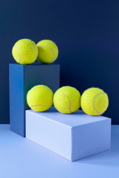 Free photo front view of tennis balls on pedestal shapes