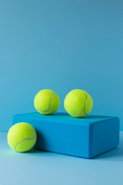 Front view of tennis balls on shape with copy space