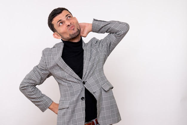 Front view thinking handsome male in suit standing on white background