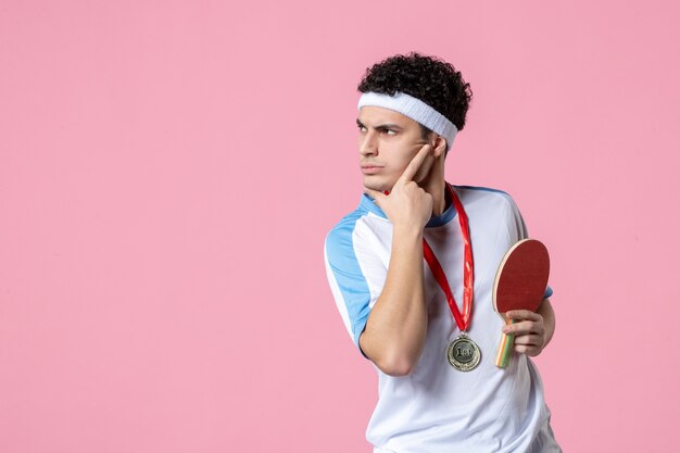 Front view thinking male athlete in sport clothes