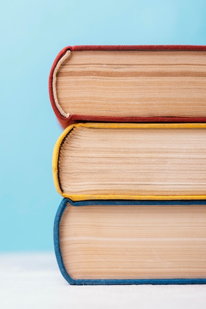 Free photo front view of three colored stacked books