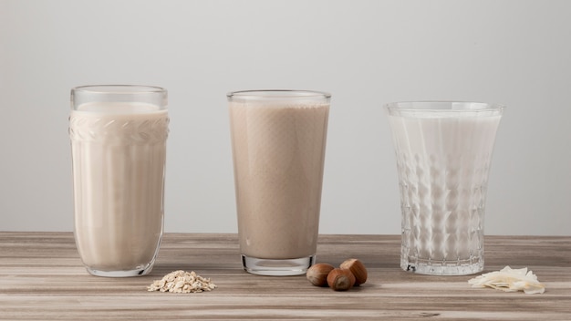 Free photo front view of three glasses of different milk