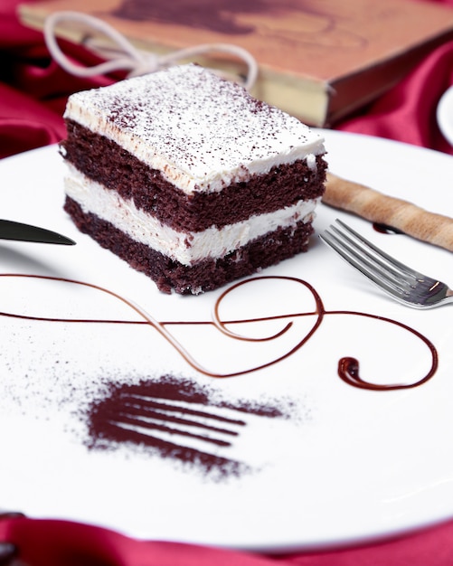 Front view tiramisu with a waffle stick on a plate with decor and a fork