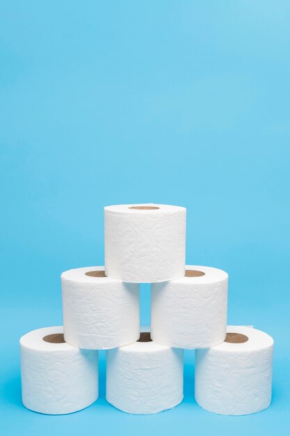 Front view of toilet paper rolls stacked in pyramid shape