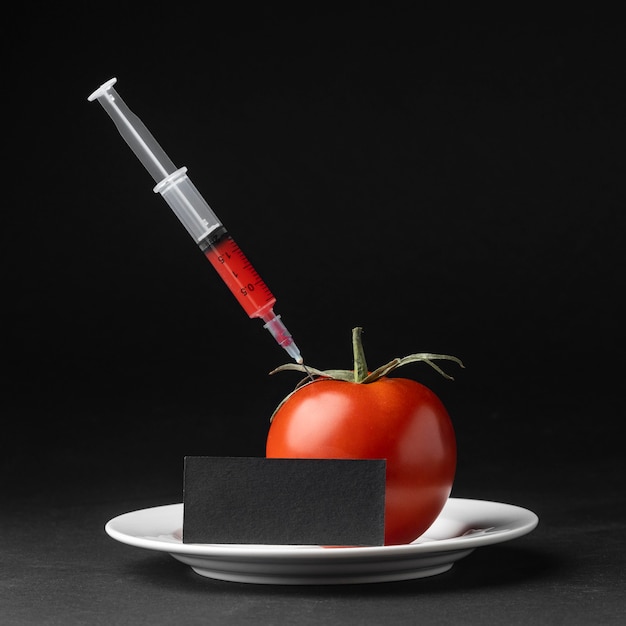 Free photo front view tomato filled with syringes