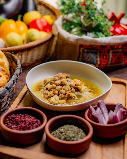 Front view traditional azerbaijani dish piti with sumac dried herbs and onions