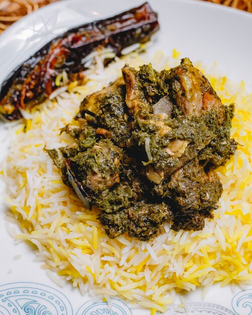 Front view traditional azerbaijani pilaf syabzi fried meat with greens and rice