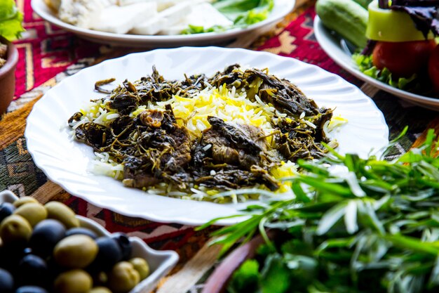 Front view traditional azerbaijani pilaf syabzi fried meat with greens and rice
