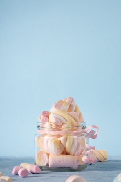 Front view of transparent jar filled with marshmallow