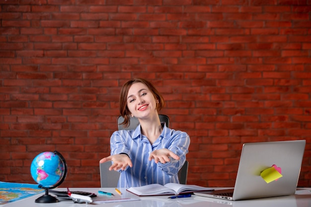 Free photo front view travel agent behind her working place map indoors manager operator agency world service occupation worker